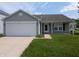 Charming single-story home with attached garage and well-maintained lawn at 901 Westpointe Dr, Shelbyville, IN 46176