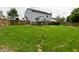 View of a spacious backyard and home exterior, with a wood fence at 9206 Huntleigh Cir, Plainfield, IN 46168
