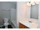 Cozy bathroom showcasing a single sink vanity with a mirror and tub with shower at 9206 Huntleigh Cir, Plainfield, IN 46168