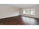 Bright bedroom featuring wood floors, neutral walls, and three windows at 9206 Huntleigh Cir, Plainfield, IN 46168