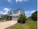 Charming two-story home featuring a two-car garage, a sunny day, and landscaping at 9206 Huntleigh Cir, Plainfield, IN 46168