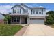 Charming two-story home featuring a covered front porch and two car garage on a sunny day at 9206 Huntleigh Cir, Plainfield, IN 46168