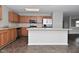 Spacious kitchen with wood cabinets, stainless steel appliances, and center island, vinyl floor, and neutral paint at 9206 Huntleigh Cir, Plainfield, IN 46168