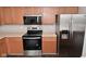 Updated kitchen features stainless steel appliances and warm wood cabinetry at 9206 Huntleigh Cir, Plainfield, IN 46168