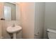 A simple powder room featuring a pedestal sink and elongated toilet at 9206 Huntleigh Cir, Plainfield, IN 46168