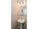 Powder room with a white pedestal sink and a large mirror at 9206 Huntleigh Cir, Plainfield, IN 46168
