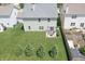 An aerial view of the home's backyard featuring a pergola patio set, lush lawn, and row of pine trees at 935 Northwich Ave, Westfield, IN 46074