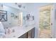 Bathroom featuring double vanity with white countertop and view into the shower with blue tile at 935 Northwich Ave, Westfield, IN 46074