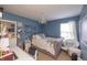 Comfortable bedroom with a cozy bed, accented by a chandelier and a serene blue color scheme at 935 Northwich Ave, Westfield, IN 46074