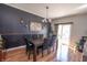 Elegant dining room with a dark accent wall, a modern chandelier, and a table set for six, perfect for entertaining at 935 Northwich Ave, Westfield, IN 46074