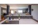 Well-lit kitchen showcasing an island sink, quartz countertops, tiled backsplash, and open access to the living area at 935 Northwich Ave, Westfield, IN 46074