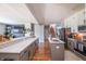 Open-concept kitchen with an island featuring a sink, stainless steel appliances, and a view of the living space at 935 Northwich Ave, Westfield, IN 46074