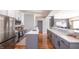 Modern kitchen boasts an island with a sink and sleek counter, stainless steel appliances, and stylish backsplash at 935 Northwich Ave, Westfield, IN 46074