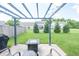 This backyard patio features a cozy pergola with string lights, a modern fire pit table, and comfortable seating at 935 Northwich Ave, Westfield, IN 46074