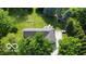 Aerial view of the property with a large yard and surrounding trees at 9390 N State Road 39, Lizton, IN 46149
