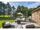 Large, well-maintained backyard with patio seating area, shed, and mature trees at 9390 N State Road 39, Lizton, IN 46149