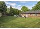 Spacious brick patio off the back of the home offers outdoor seating and a grill at 9390 N State Road 39, Lizton, IN 46149