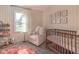 Charming Bedroom with a crib, rocking chair, and natural light creating a warm atmosphere at 9390 N State Road 39, Lizton, IN 46149