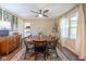 Sunlit dining room with wood floors, modern ceiling fan, and beautiful decor at 9390 N State Road 39, Lizton, IN 46149