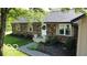 View of home from side with brick exterior, flower pots and manicured landscaping at 9390 N State Road 39, Lizton, IN 46149