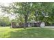Single story ranch home with brick exterior and two car garage under mature trees at 9390 N State Road 39, Lizton, IN 46149
