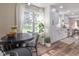 Eat-in kitchen with a round dining table, large window, and white cabinets at 9390 N State Road 39, Lizton, IN 46149