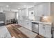 Charming kitchen featuring white cabinets, stainless steel appliances, and warm wood-look floors at 9390 N State Road 39, Lizton, IN 46149