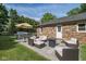 Outdoor patio features a modern seating area, grill, dining, and a beautiful brick house at 9390 N State Road 39, Lizton, IN 46149
