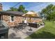 Outdoor brick patio features a grill, table and chairs, umbrella, and modern outdoor seating at 9390 N State Road 39, Lizton, IN 46149