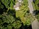Aerial view of property with mature trees, well-maintained yard, and nearby road at 9705 Valley Springs Blvd, Fishers, IN 46037