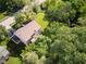 An aerial view of a tan house with a brown roof surrounded by vibrant green trees at 9705 Valley Springs Blvd, Fishers, IN 46037