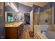 This full bathroom features a double sink vanity, shower, garden tub and blue walls at 9705 Valley Springs Blvd, Fishers, IN 46037