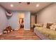 Cozy bedroom featuring hardwood floors, with a daybed, and access to closet at 9705 Valley Springs Blvd, Fishers, IN 46037