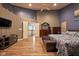 Spacious primary bedroom featuring vaulted ceilings, a ceiling fan, and wood flooring at 9705 Valley Springs Blvd, Fishers, IN 46037