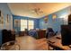 Blue bedroom with desk, blue gaming chair, and natural light streaming through a window at 9705 Valley Springs Blvd, Fishers, IN 46037