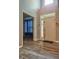 Inviting foyer with wood-look flooring, tall ceilings, and views into the adjacent living area at 9705 Valley Springs Blvd, Fishers, IN 46037