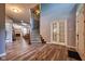 Open foyer view showcasing wood-look floors, staircase, and access to the living room at 9705 Valley Springs Blvd, Fishers, IN 46037