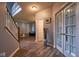 Inviting foyer with wood-look flooring, staircase, and access to the living areas at 9705 Valley Springs Blvd, Fishers, IN 46037