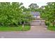 Attractive home exterior with a three-car garage, mature trees, and manicured lawn at 9705 Valley Springs Blvd, Fishers, IN 46037