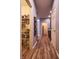 Hallway with pantry and access to rooms on either side; features hardwood floors at 9705 Valley Springs Blvd, Fishers, IN 46037