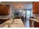 Kitchen featuring granite countertops, wood cabinets, stainless appliances, and an open layout at 9705 Valley Springs Blvd, Fishers, IN 46037