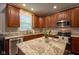 Kitchen with granite countertops, stainless appliances, and cherry wood cabinets at 9705 Valley Springs Blvd, Fishers, IN 46037
