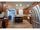 Modern kitchen with stainless steel appliances, a large island, and wood cabinets at 9705 Valley Springs Blvd, Fishers, IN 46037