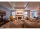 Comfortable living room with a fireplace, large sectional sofa, and recessed lighting at 9705 Valley Springs Blvd, Fishers, IN 46037