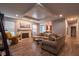 Spacious living room with a fireplace, wood floors, and an open layout to the kitchen at 9705 Valley Springs Blvd, Fishers, IN 46037