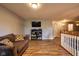 Relaxing upstairs living room with hardwood floors, neutral colors and television at 9705 Valley Springs Blvd, Fishers, IN 46037