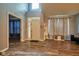 This is a well-lit living room with wood floors and an elegant entryway. It also has a sitting bench at 9705 Valley Springs Blvd, Fishers, IN 46037