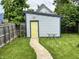 Outdoor shed in backyard with pathway, garden, and green grass at 1001 Harlan St, Indianapolis, IN 46203