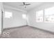Bright bedroom with plush carpet, neutral walls and lots of natural light from multiple windows at 1001 Harlan St, Indianapolis, IN 46203