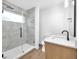 Modern bathroom with glass shower, neutral tile, and a wooden vanity at 1027 Hosbrook St, Indianapolis, IN 46203